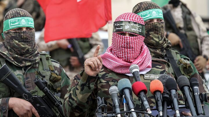Abu Ubaida (C), spokesman of the Ezzedine al-Qassam Brigades, the military wing of the Palestinian Islamist movement Hamas, speaks during a memorial in the southern Gaza Strip town of Rafah on January 31, 2017, for Mohamed Zouari, a 49-year-old Tunisian engineer and drone expert, who was murdered at the wheel of his car outside his house in Tunisia in December 2016. 
The armed wing of Hamas said that the Jewish state was responsible for the murder in eastern Tunisia, of Mohamed Zaouari, described as a leader of the Islamist movement specializing in the development of drones. / AFP / SAID KHATIB        (Photo credit should read SAID KHATIB/AFP via Getty Images)