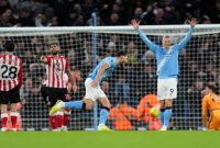 Manchester City's Ruben Dias (centre) celebrates with Bernardo Silva after scoring their side's first goal of the game during the Premier League match at the Etihad Stadium, Manchester. Picture date: Saturday December 6, 2025. (Photo by Martin Rickett/PA Images via Getty Images)