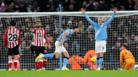 Manchester City's Ruben Dias (centre) celebrates with Bernardo Silva after scoring their side's first goal of the game during the Premier League match at the Etihad Stadium, Manchester. Picture date: Saturday December 6, 2025. (Photo by Martin Rickett/PA Images via Getty Images)