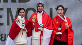 Mubarokah Dewi Laila of Indonesia, the gold medalist, celebrates on the podium during the medal ceremony with Karini Dominique Rachmawati of Indonesia, the silver medalist, and Phi Thanh Thao of Vietnam, the bronze medalist, at the women's 10m Air Rifle final at the 33rd Sea Games in SAT Shooting Range, Bangkok, Thailand, on December 13, 2025. (Photo by Anusak Laowilas/NurPhoto via Getty Images)
