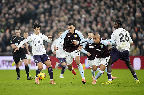 Manchester United's Lisandro Martinez (left) and Aston Villa's Morgan Rogers (second right) battle for the ball during the Premier League match at Villa Park, Birmingham. Picture date: Sunday December 21, 2025. (Photo by Nick Potts/PA Images via Getty Images)