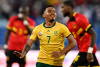South Africa's midfielder #07 Oswin Appollis (C) celebrates scoring his team's first goal during the Africa Cup of Nations (CAN) Group B football match between South Africa and Angola at Marrakesh Stadium in Marrakesh, Morocco on December 22, 2025. (Photo by Khaled DESOUKI / AFP via Getty Images)