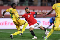 TOPSHOT - Egypt's forward #10 Mohamed Salah scores the team's second goal during the Africa Cup of Nations (CAN) group B football match between Egypt and Zimbabwe at Adrar Stadium in Agadir on December 22, 2025. (Photo by FRANCK FIFE / AFP via Getty Images)