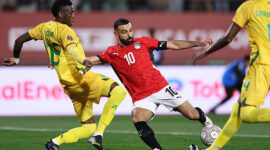 TOPSHOT - Egypt's forward #10 Mohamed Salah scores the team's second goal during the Africa Cup of Nations (CAN) group B football match between Egypt and Zimbabwe at Adrar Stadium in Agadir on December 22, 2025. (Photo by FRANCK FIFE / AFP via Getty Images)