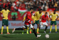 Egypt's forward #10 Mohamed Salah shoots from the penalty spot to score the team's first goal during the Africa Cup of Nations (CAN) Group B football match between Egypt and South Africa at Adrar Stadium in Agadir on December 26, 2025. (Photo by FRANCK FIFE / AFP via Getty Images)