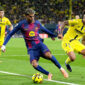 VILLARREAL, SPAIN - DECEMBER 21: Lamine Yamal of FC Barcelona is challenged by Tajon Buchanan of Villarreal CF during the LaLiga EA Sports match between Villarreal CF and FC Barcelona at Estadio de la Ceramica on December 21, 2025 in Villarreal, Spain. (Photo by Alex Caparros/Getty Images)