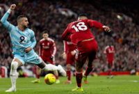 LIVERPOOL, ENGLAND - JANUARY 17: Cody Gakpo of Liverpool passes the ball as he is being challenged by Kyle Walker of Burnley during the Premier League match between Liverpool and Burnley at Anfield on January 17, 2026 in Liverpool, England. (Photo by Gaspafotos/MB Media/Getty Images)