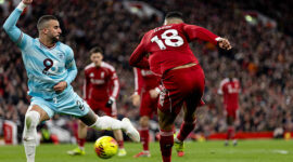 LIVERPOOL, ENGLAND - JANUARY 17: Cody Gakpo of Liverpool passes the ball as he is being challenged by Kyle Walker of Burnley during the Premier League match between Liverpool and Burnley at Anfield on January 17, 2026 in Liverpool, England. (Photo by Gaspafotos/MB Media/Getty Images)