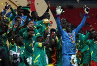 Senegal players celebrate with the trophy after winning the Africa Cup of Nations (CAN) final football match against Morocco at the Prince Moulay Abdellah Stadium in Rabat on January 18, 2026. (Photo by FRANCK FIFE / AFP via Getty Images)