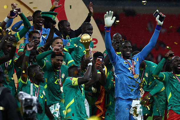 Senegal players celebrate with the trophy after winning the Africa Cup of Nations (CAN) final football match against Morocco at the Prince Moulay Abdellah Stadium in Rabat on January 18, 2026. (Photo by FRANCK FIFE / AFP via Getty Images)